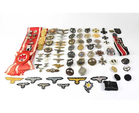 A quantity of period and later reproductions of Third Reich and SS cap badges, cloth badges, epaulettes, pin badges, etc, als