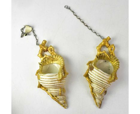 ROYAL WORCESTER; a pair of gilt-heightened wall pockets in the form of conch shells with coral forming the hanger, with puce 