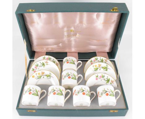 MINTON; a cased coffee set in the 'Meadow' pattern S.745, comprising six coffee cans and saucers with floral decoration, in p