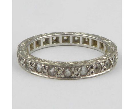 A 9ct white gold eternity ring with tiny channel set white stones, size K, approx. 2.4g.Condition Report: - The stones are no
