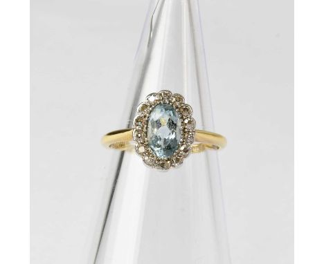 An 18ct gold cluster ring set with an aquamarine in a surround of fourteen diamonds in white gold setting, stamped '18CT', si