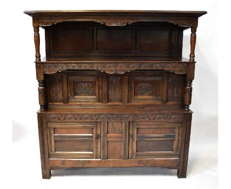 An early 18th century Welsh oak cwpwrdd tridarn with upper shelf above middle section, with pair of cupboard doors, on a base