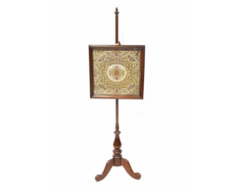 A 19th century mahogany fire screen with glazed tapestried panel, on a turned column and tripod base, height 154cm.