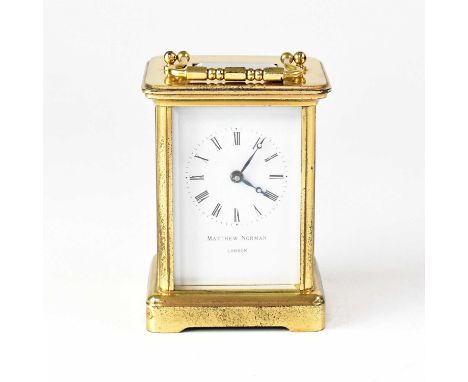MATTHEW NORMAN; a contemporary single drum movement carriage clock, the white enamelled dial set with Roman numerals, inscrib