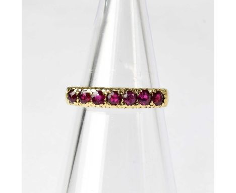A 9ct gold ruby set half eternity ring, stamped '375', size M1/2, approx. 2.1g.