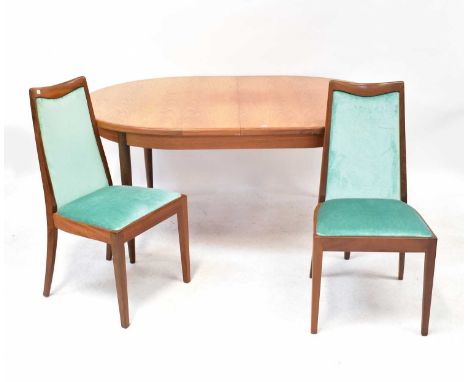 G-PLAN; a teak extending dining table with one integral leaf, on turned tapering legs, 74 x 166 x 110cm, together with a set 