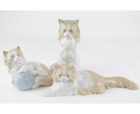 NAO; three porcelain cat figures, height of tallest 18cm (3).