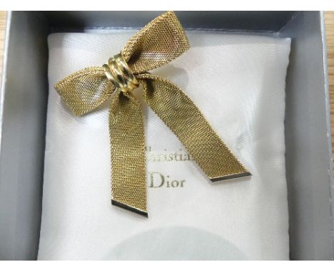 A vintage Christian Dior Bow Brooch, marked on the reverse '1972, Chr. Dior Germany', on original packaging cushion, together