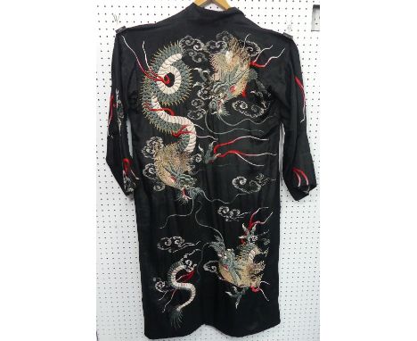 Japanese textiles: a vintage padded black silk Kimono, the reverse extravagantly embroidered in relief with three three-toed 