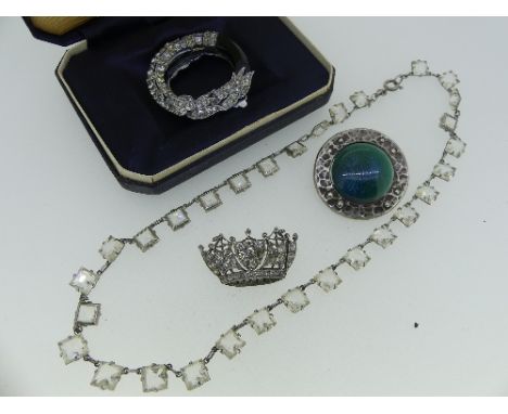 A quantity of Paste set Jewellery, including a white paste necklet, two bow brooches, a paste Naval Crown, two pastes missing