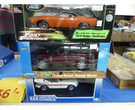 Three 1:18 scale diecast metal model Cars, all boxed, comprising Universal Hobbies MGB GT Police Car, Welly Premium Collectio