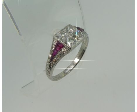 A diamond and ruby Art Deco style Ring, the square front set with four invisibly set Old French Cut diamonds, each circa 0.28