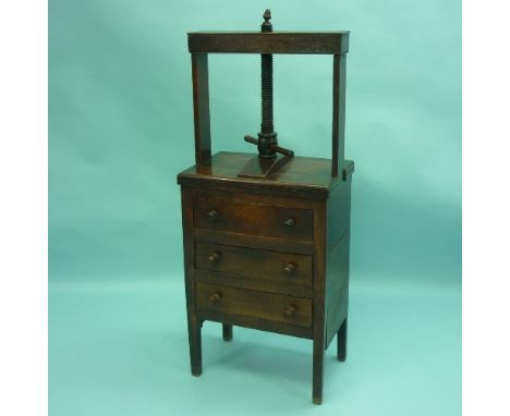 A George III oak Book Press on Chest of Drawers, the rectangular press with turned thread and acorn finial, above three long 