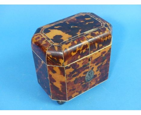 A Regency period tortoiseshell Tea Caddy, of shaped octagonal form with ivory stringing and four metallic ball feet, the hing