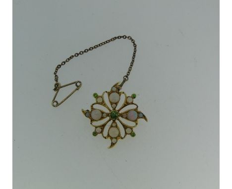 An opal Pendant / Brooch, the openwork flowerhead, set with opals and demantoid garnet points, all mounted in yellow metal, 1