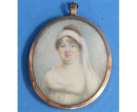 Early 19th century School, a miniature portrait of a young woman wearing a head scarf, oval, watercolour, in a gilt metal fra