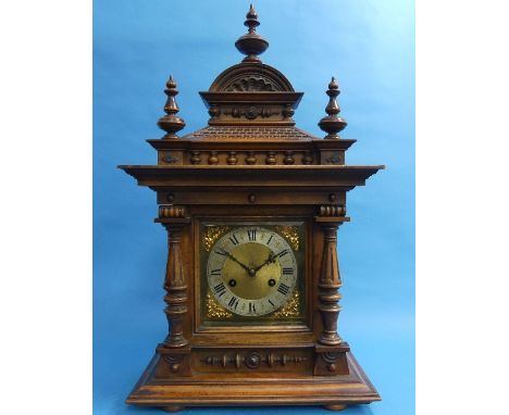 An early 20th century German walnut Mantel Clock, with 8-day movement striking on a gong, the brass dial with silvered chapte