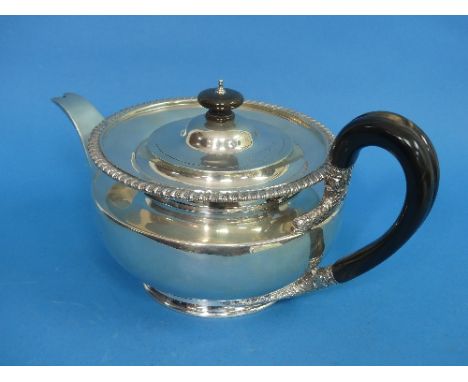 A George V silver Teapot, by Goldsmiths &amp; Silversmiths Co Ltd., hallmarked London, 1919, of plain circular form with gadr