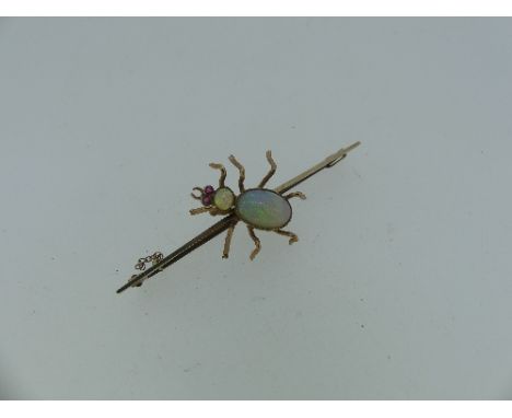An early 20thC 9ct gold Bar Brooch, the centre set with a spider formed with an opal abdomen and head and red glass eyes, tot
