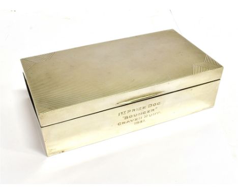 AN ART DECO SILVER RECTANGULAR CIGARETTE BOX with engine turned cover and inscribed '1st Prize Dog 'Bouncer' Craven Hunt, 193