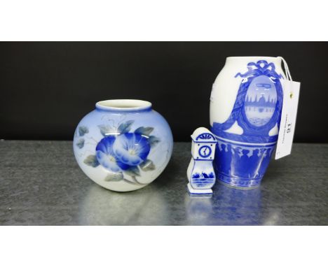 Two Royal Copenhagen porcelain vases and a miniature Delft longcase clock, tallest 14cm high (3)