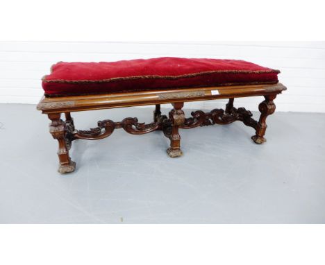 A 19th century mahogany hall bench with a padded seat over moulded top, raised on carved supports and stretchers, 130 x 49 cm