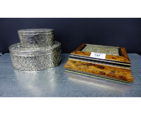 Two oval metal trinket boxes with foliate design, together with a burr wood box with white metal floral panel to the lid, sta