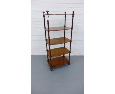 A 19th century mahogany what not having turned wood finials, over five shaped tiers with fluted supports  raised on bun feet 