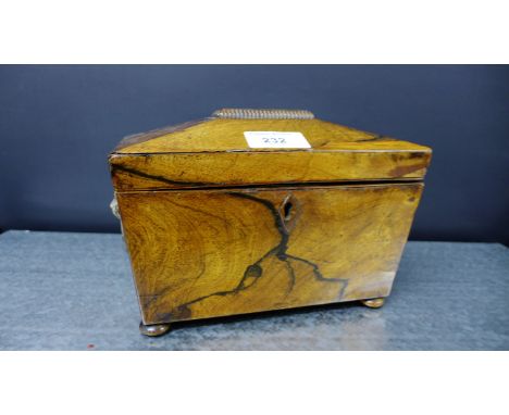 A 19th century rosewood tea caddy of sarcophagus form, the hinged lid opening to reveal two compartments, raised on bun feet,