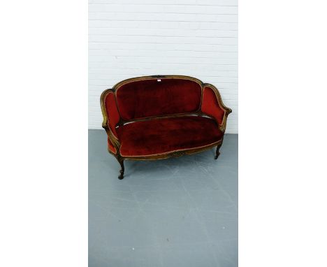 A 19th century mahogany framed two seater parlour sofa with padded back support and sprung seat, raised on scroll work feet a