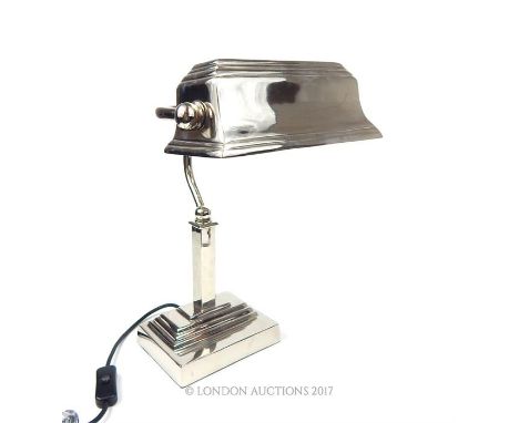 A contemporary chromed bankers desk lamp with adjustable shade, raised on a rectangular section step down base, 39 x 24 x 26c