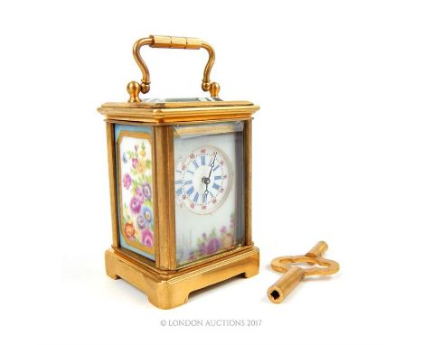 A miniature carriage click with ceramic sides; Roman numeral dial; 6cm high,