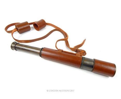 A vintage four drawer field telescope with pig skin leather casing; stamped "Dollond London".