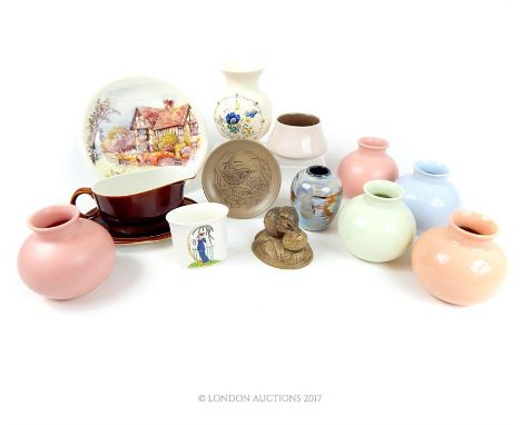 A collection of Poole pottery items including spherical vases in pastel hues, a lustre vase and others.