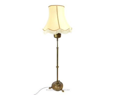 A fine, brass, Arts and Crafts standing lamp with extending stem, rounded, flat base on three, distinctive out-swept feet wit