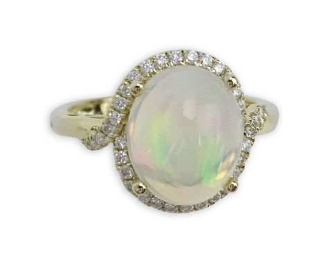 Approx. 3.09 Carat White Opal, Diamond and 14 Karat Yellow Gold Ring. Signed 14K. Very good condition. Ring size 7. Approx. w