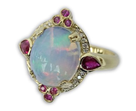 Approx. 3.05 Carat White Opal and 14 Karat Yellow Gold Ring accented with Small Rubies and Round Cut Diamonds. Signed 14K. Ve