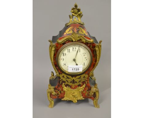Late 19th or early 20th Century buhl mantel clock with a cut brass and red stained tortoiseshell front panel, the ebonised an