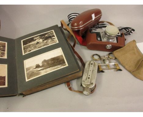 Pair of folding opera glasses, a camera and a postcard album 