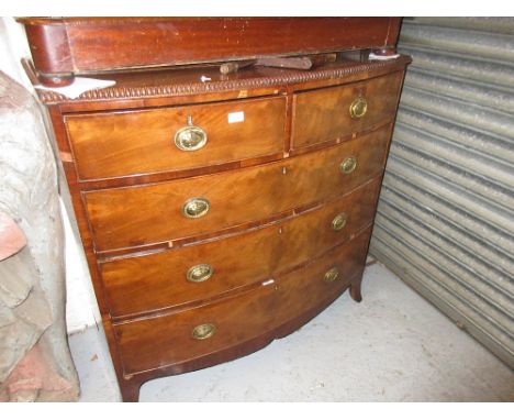 Regency mahogany bow front chest of two short and three long drawers with oval brass handles and splay bracket feet beneath a