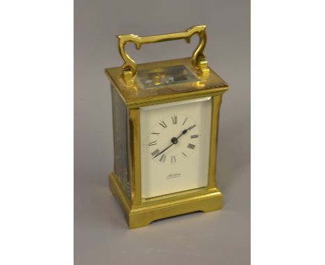 20th Century brass cased carriage clock with key, the dial inscribed ' Sladdens, Canterbury ' 
