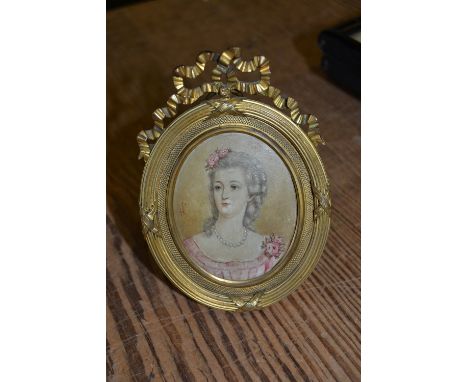 Oval portrait miniature of a lady housed in a good quality ormolu frame with bow surmount 