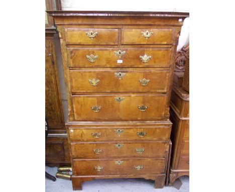 George I walnut tallboy, the moulded cornice above two short and six long drawers with brass handles and escutcheons, flanked