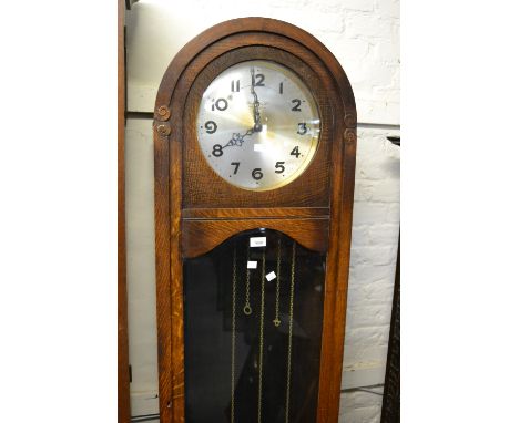 Early to mid 20th Century oak longcase clock, the silvered dial with Arabic numerals, signed Bravingtons Ltd, Kings Cross and