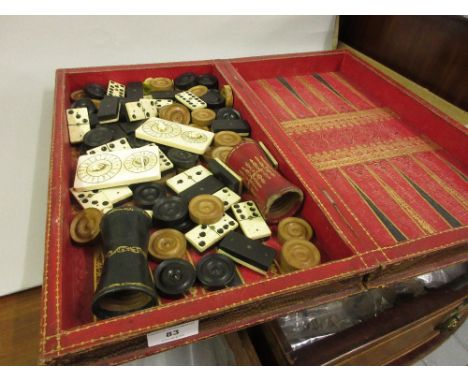 Folding leather covered draughts and backgammon board, quantity of bone and ebony dominoes, a boxwood draughts set and a pair