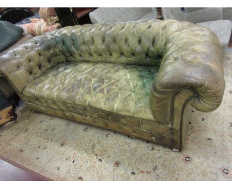Large green button leather upholstered chesterfield sofa, raised on low bun feetHas been re-coloured at some point, multiple 