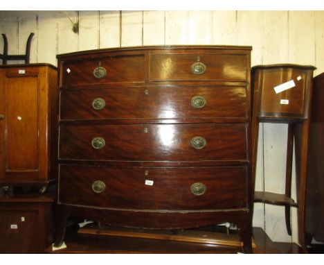 19th Century mahogany bow front chest of two short and three long drawers with oval brass handles and bracket feet (at fault)