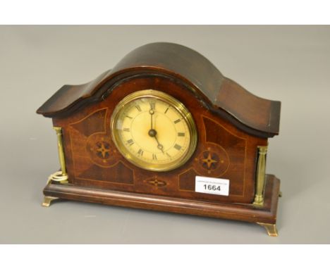 Edwardian mahogany marquetry inlaid dome top mantel clock, the dial with Roman numerals flanked by two brass columns 