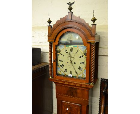 Early 19th Century mahogany longcase clock, the broken arch hood with flanking spiral pilasters, shaped surmount and brass fi