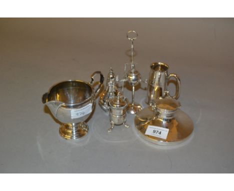 Silver capstan inkwell, sterling silver jug, silver tot measure, two silver condiments and a Continental 925 table lighter 